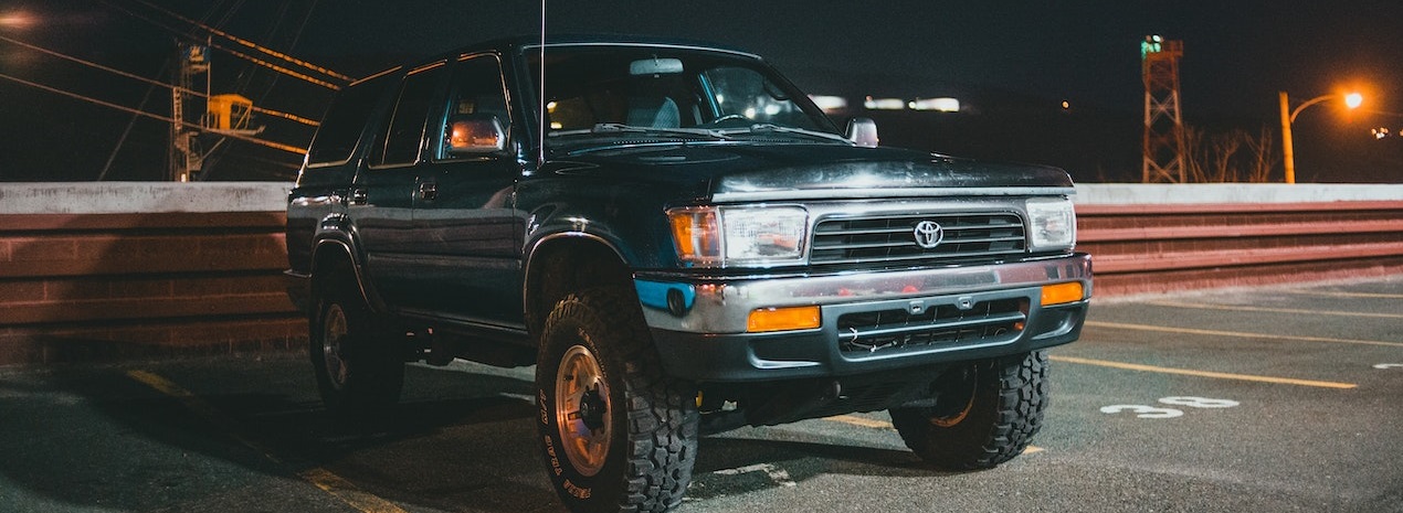 black SUV parked on parking lot | Breast Cancer Car Donations