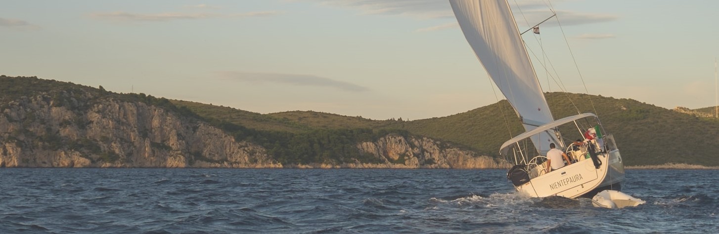 white sailing boat on body of water photo | Breast Cancer Car Donations