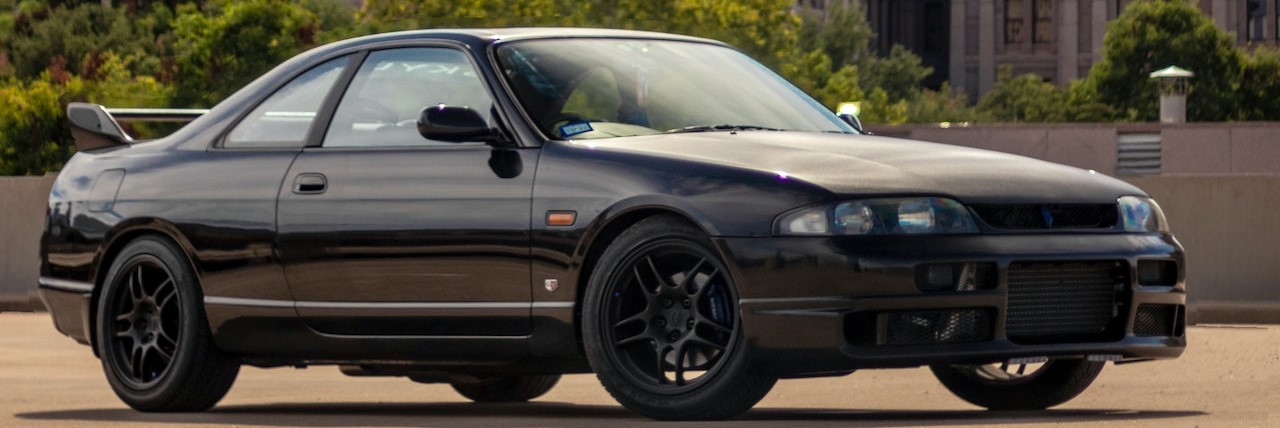 A Black Sedan Car Parked beside a Building | Breast Cancer Car Donations