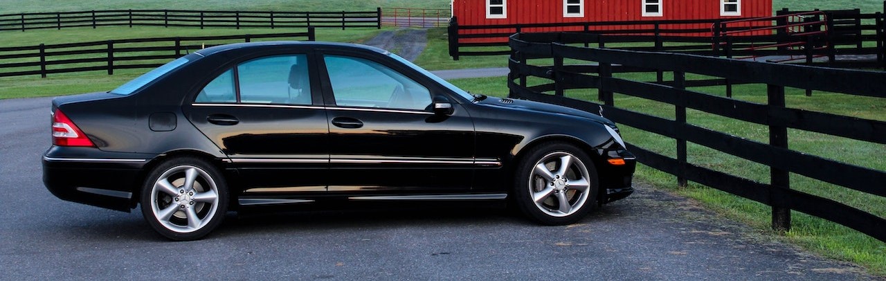 Black Coupe Near Black Wooden Fence | Breast Cancer Car Donations