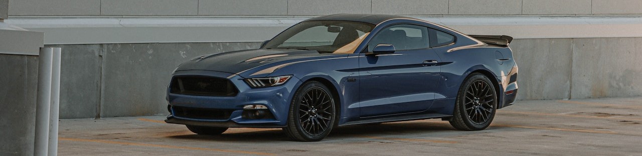 Blue Coupe Parked on Brown Wooden Floor | Breast Cancer Car Donations