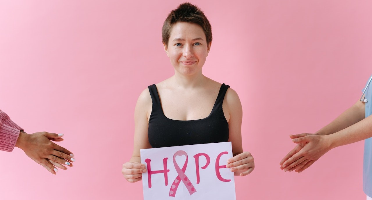 Girl holding a hope signage | Breast Cancer Car Donations