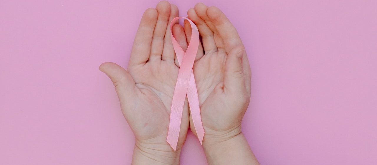 Hands Holding Pink Ribbon | Breast Cancer Car Donations
