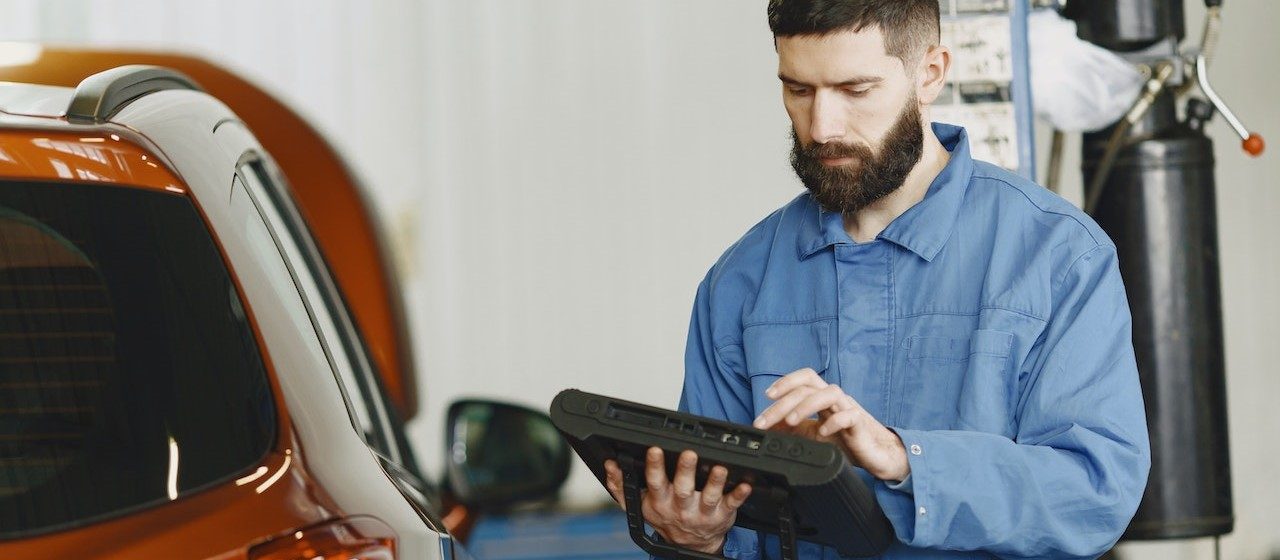 Man doing a car diagnostic | Breast Cancer Car Donations