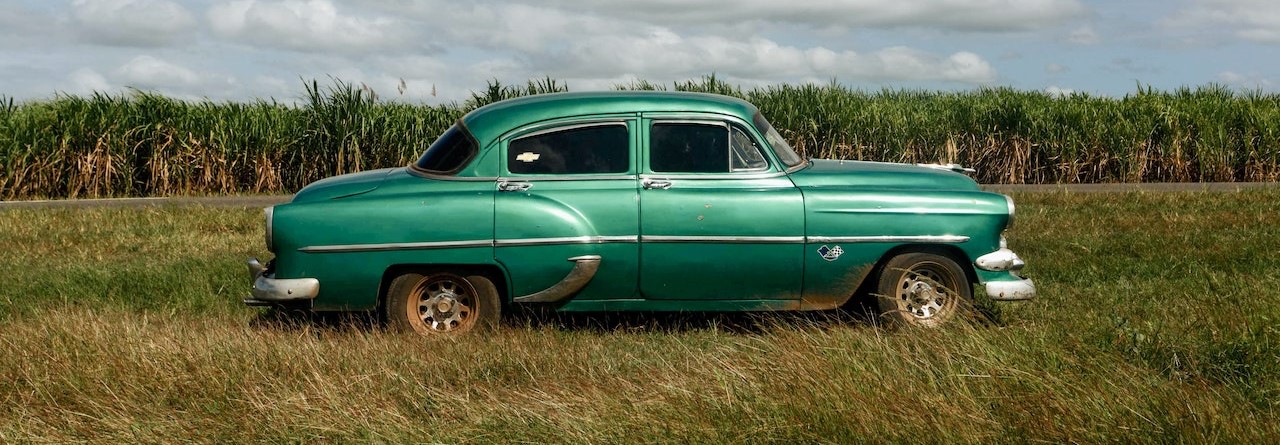 Old Vintage Car Parked on Grass Field | Breast Cancer Car Donations