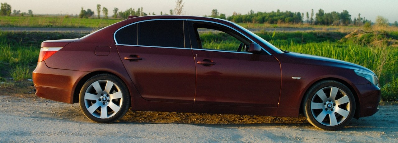 Red Sedan Car Parked Near Green Grass | Breast Cancer Car Donations