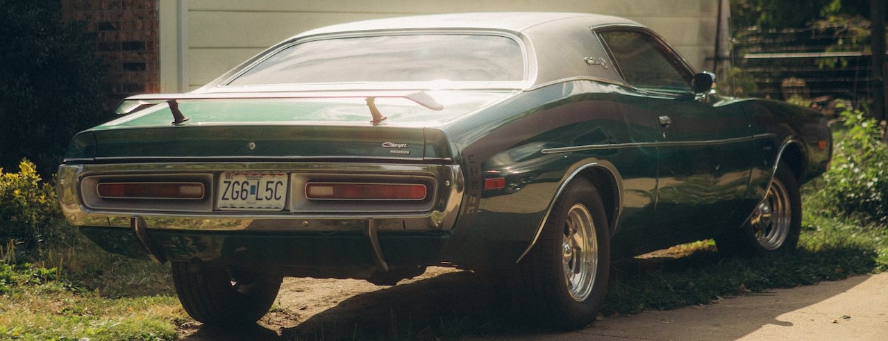 Vintage Car Parked Outside Concrete House | Breast Cancer Car Donations