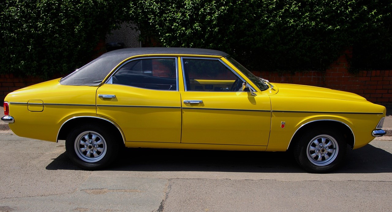 Yellow convertible sedan parked | Breast Cancer Car Donations