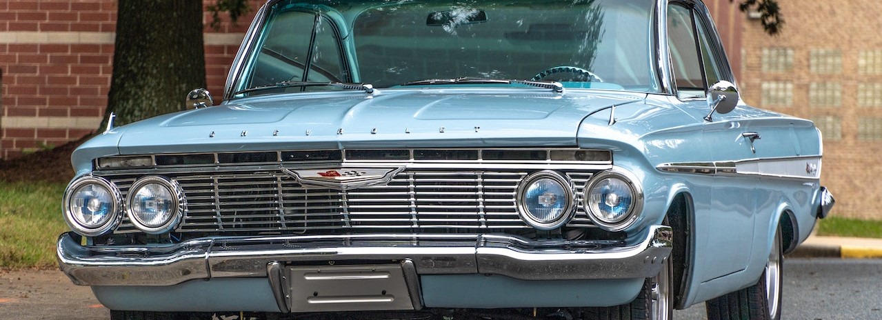 A Light Blue Chevy Car Parked Beside a Tree | Breast Cancer Car Donations