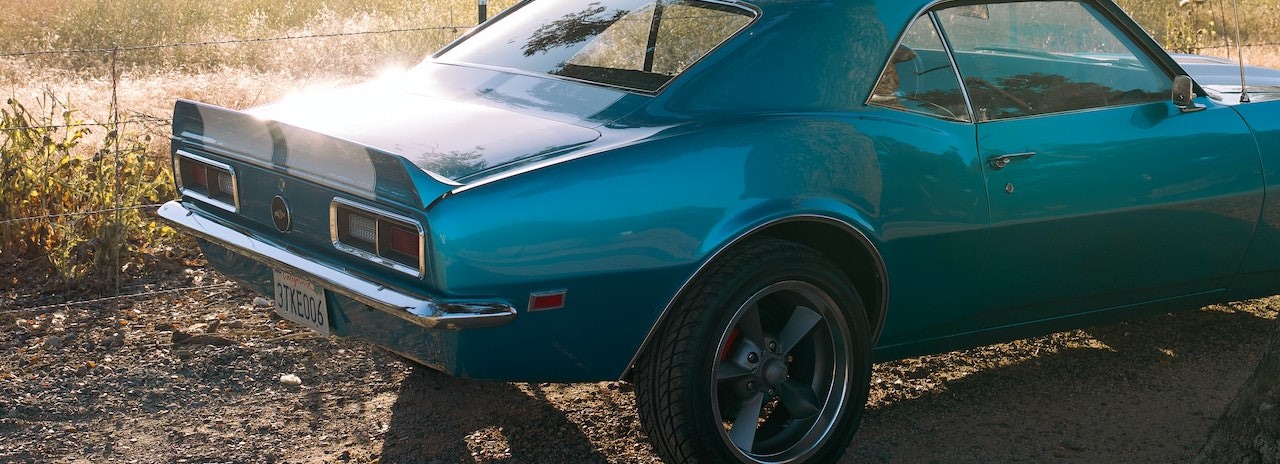 Blue Chevrolet Camaro Parked on Dirt Road | Breast Cancer Car Donations
