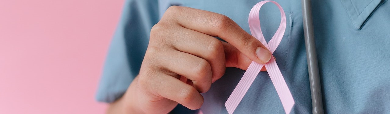 Medical Professional holding Pink Ribbon | Breast Cancer Car Donations