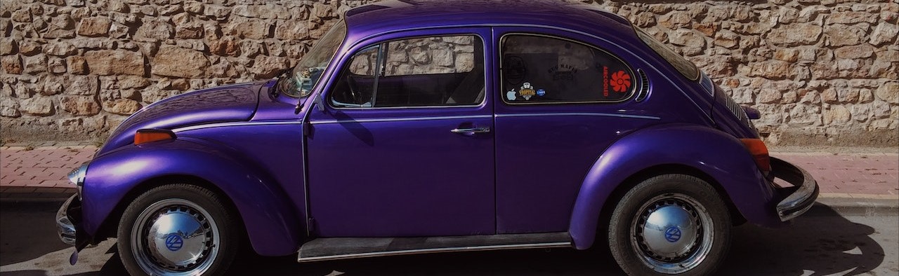 Purple Volkswagen Beetle Parked on the Street | Breast Cancer Car Donations
