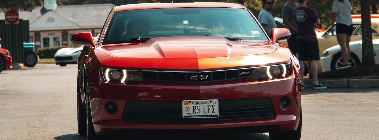 Red Chevrolet Camaro on Car Park | Breast Cancer Car Donations