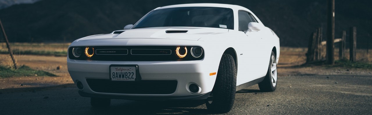 White Dodge Charger on the Road | Breast Cancer Car Donations