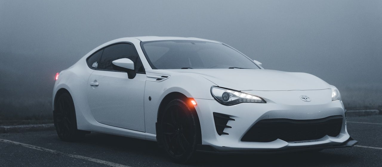 White Toyota GT86 on a Parking Lot in Fog | Breast Cancer Car Donations