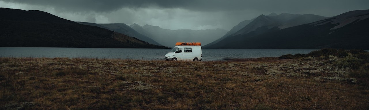 White Mini Van Parked on Overlooking Sea | Breast Cancer Car Donations