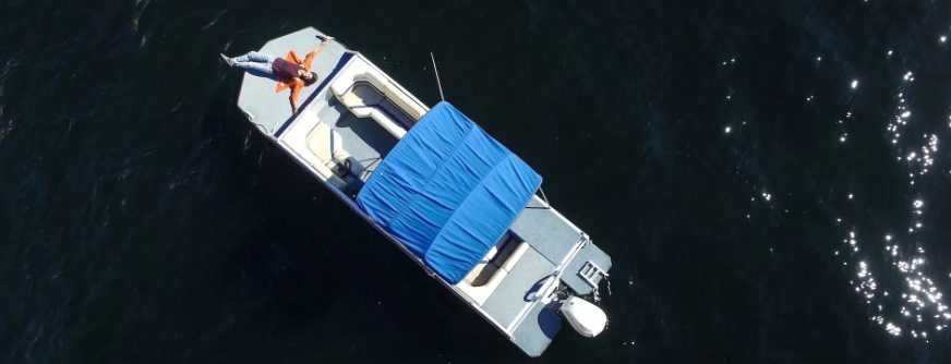 Aerial Shot of a Gray Boat with a Person Lying Down | Breast Cancer Car Donations