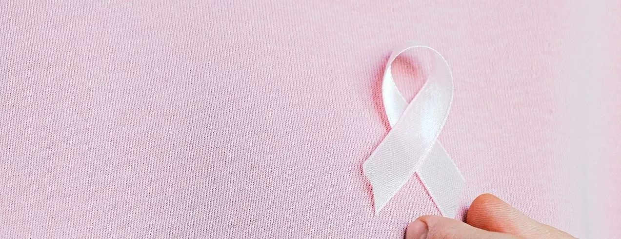 Woman Wearing Pink Ribbon | Breast Cancer Car Donations