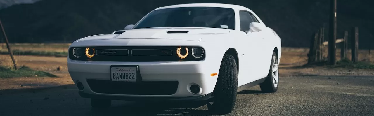 White Dodge Charger on the Road | Breast Cancer Car Donations