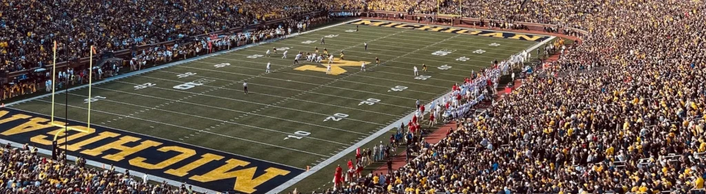 A football stadium full of fans and a football field
