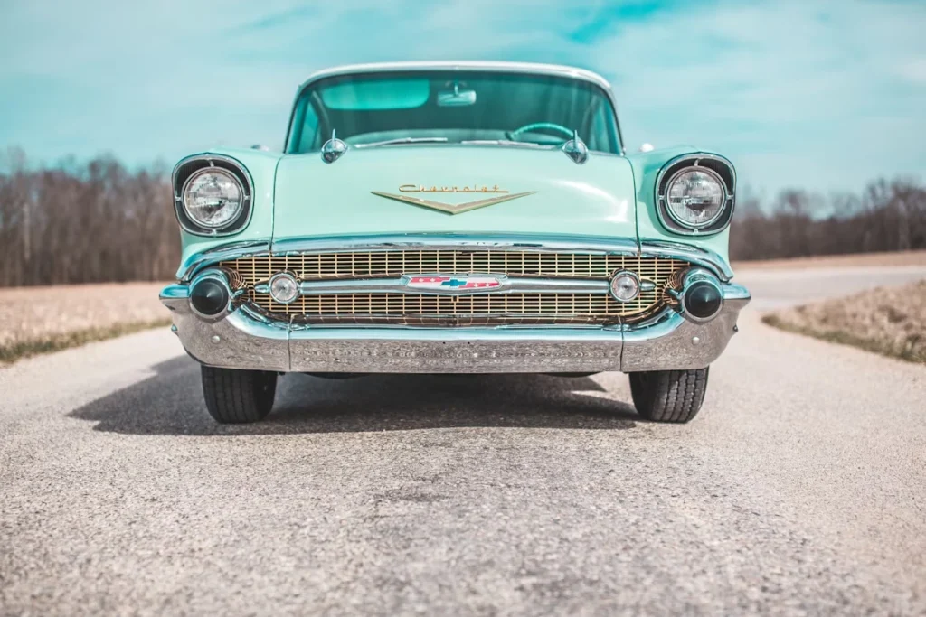 Low-angle photo of classic teal Chevrolet car