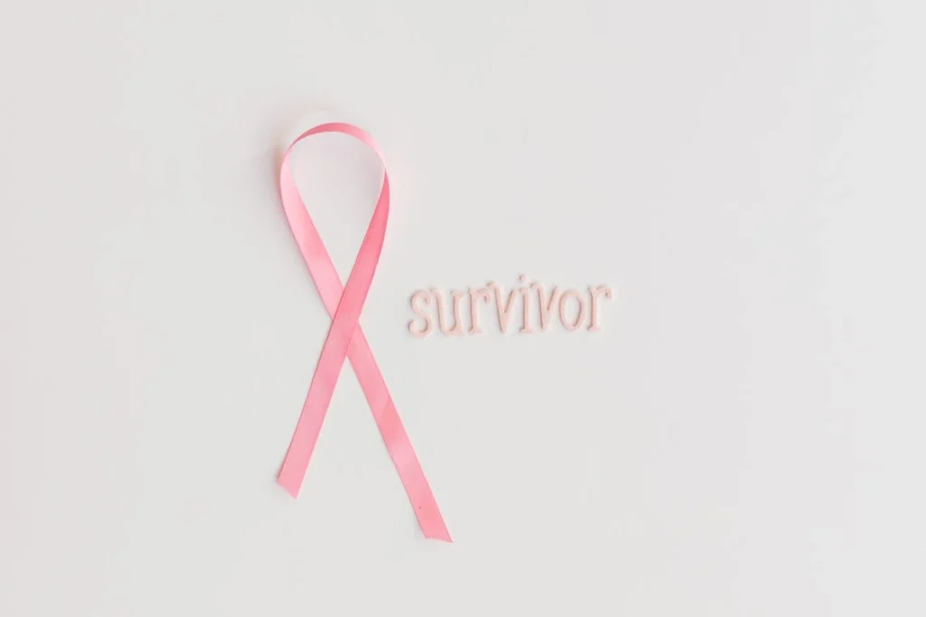 Pink ribbon with 'survivor' text symbolizing breast cancer awareness
