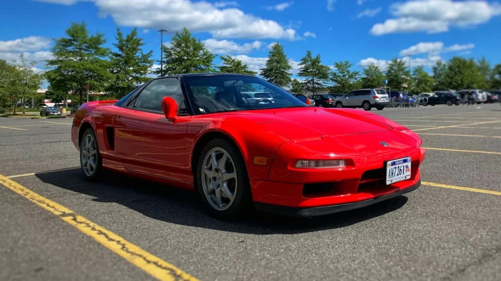 Red Ferrari sports car on road during daytime