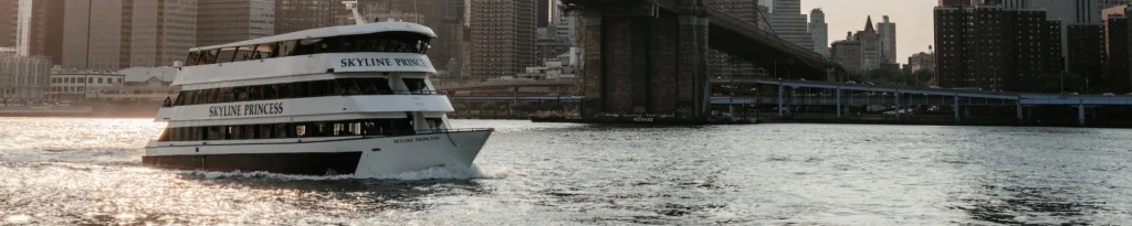 a large boat in the water near a bridge