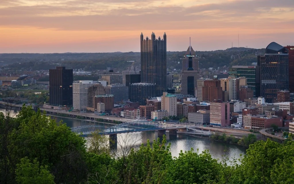 Scenic aerial view of Pittsburgh skyline at twilight with iconic skyscrapers and vibrant sunset