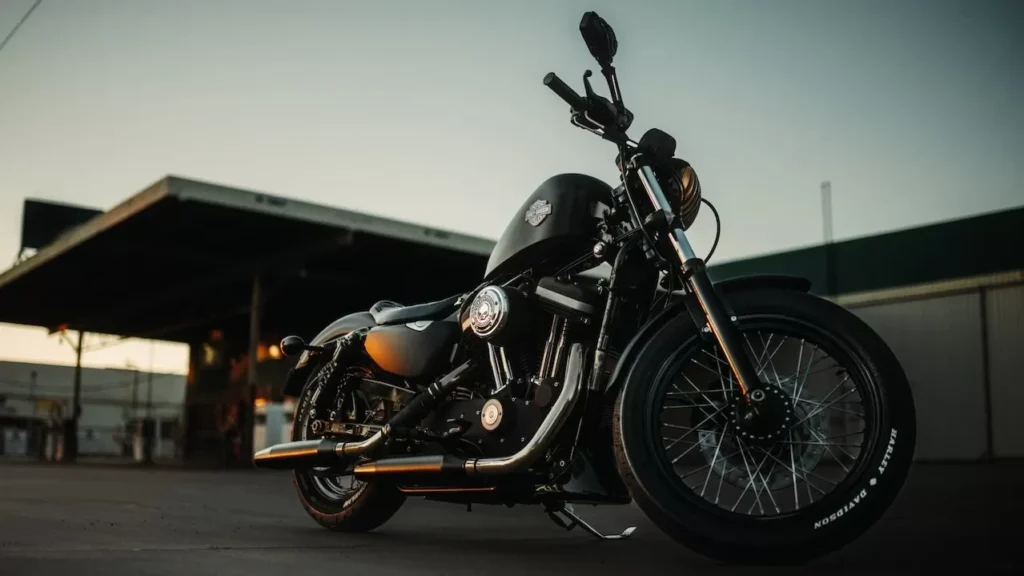 Black motorcycle parked outdoors during sunset, capturing an adventurous vibe