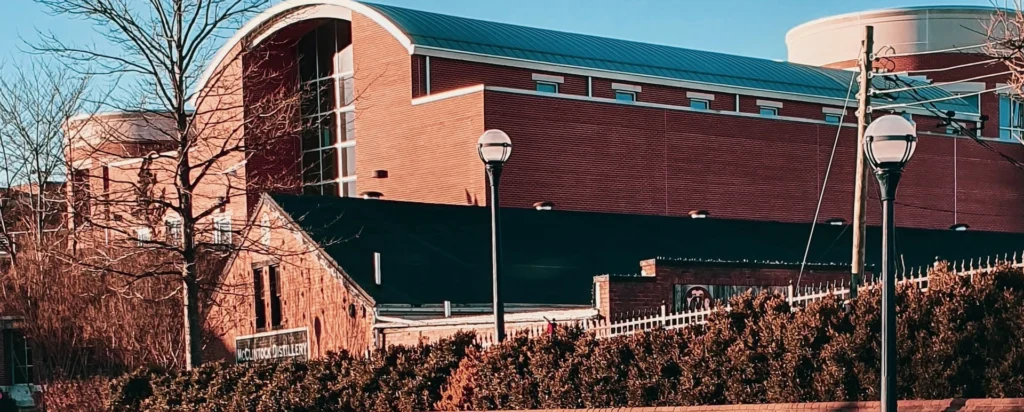 Brown brick building near body of water during daytime