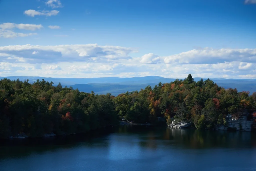 Green trees near body of water under blue sky during daytime, Lake Minnewaska