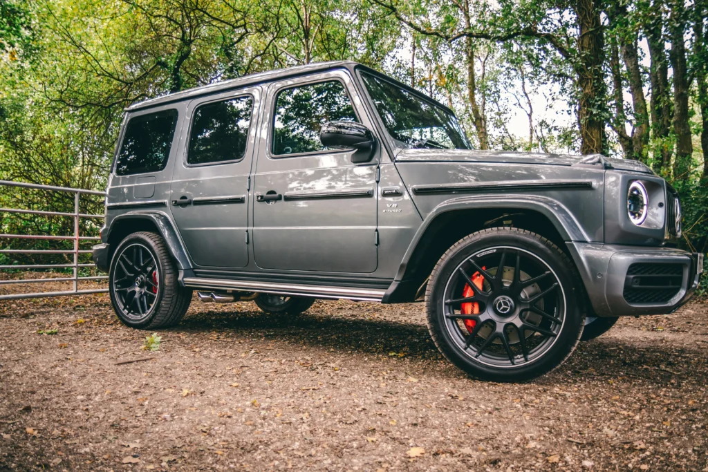 A luxurious Mercedes-Benz SUV parked in a scenic wooded area, showcasing elegance and power