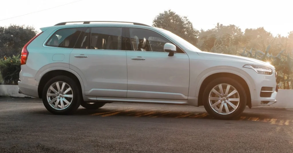 A stylish white luxury SUV captured in side view on a sunny day