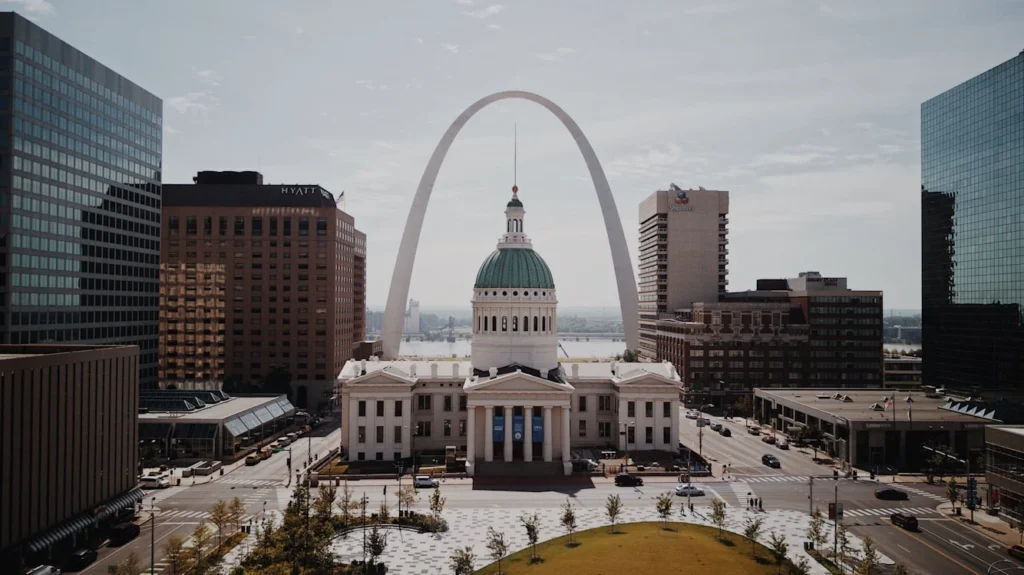 White and green dome cathedral in between high-rise buildings during daytime, St. Louis