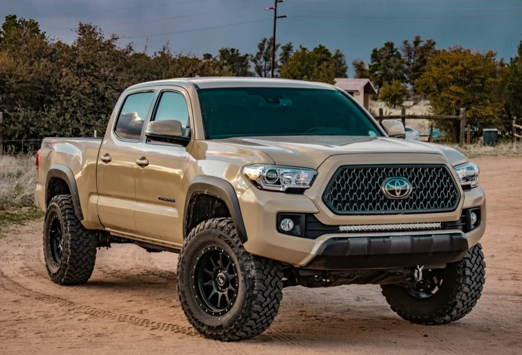 White Toyota crew cab pickup truck on ground