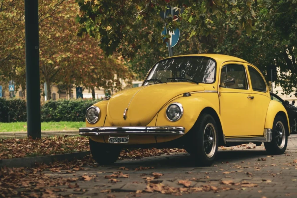 A yellow car parked on the side of the road