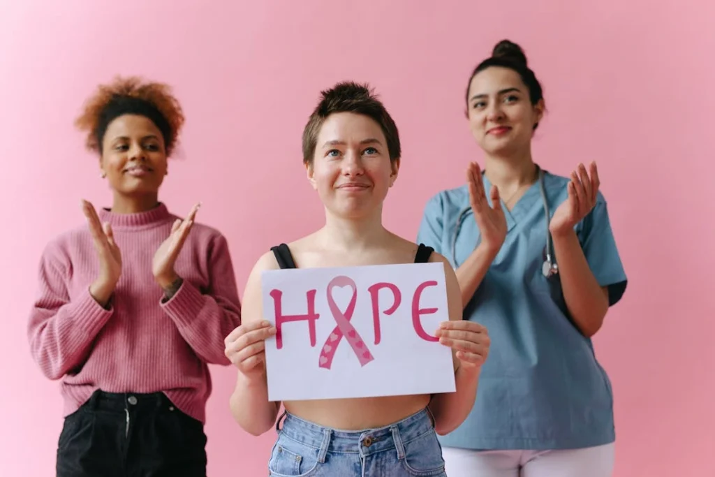 Breast cancer survivor holding a message of hope alongside supporters
